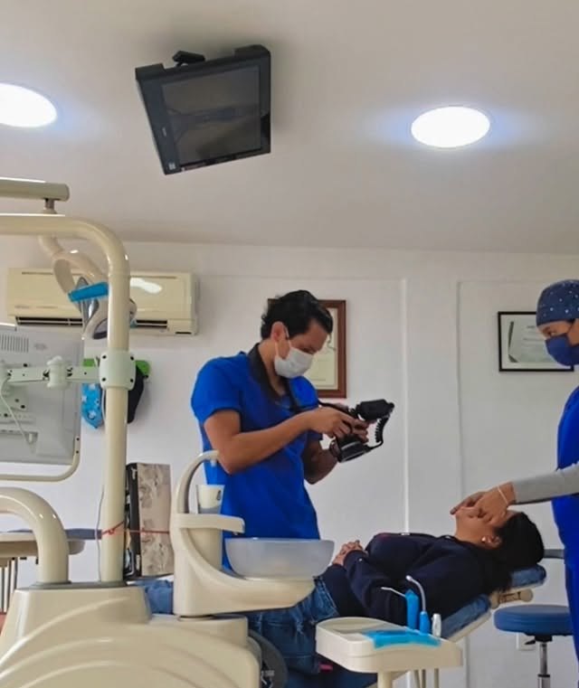 Dr. Fernando Robledo tomando fotografía clínica a una paciente