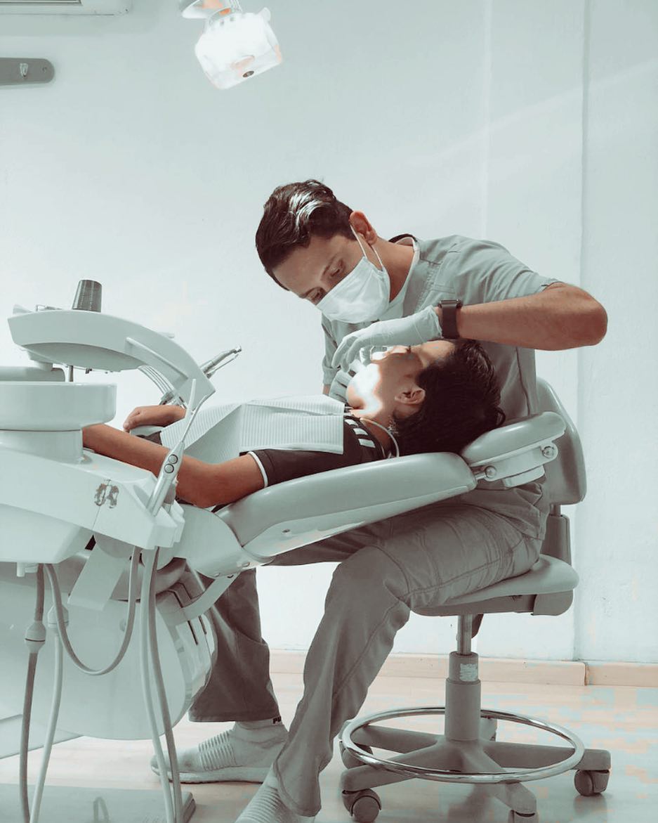 Dr. Fernando Robledo atendiendo a un paciente en el sillón dental